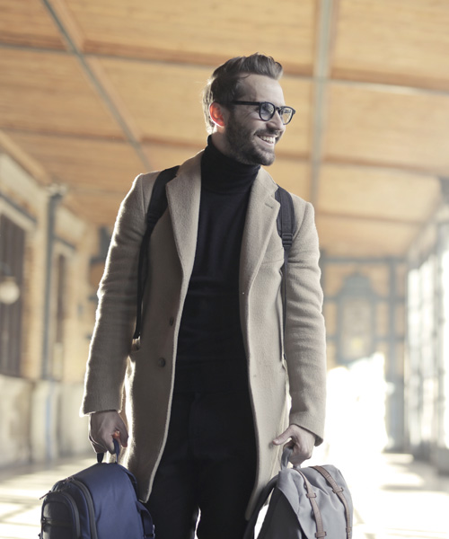 smiling man holding two bags